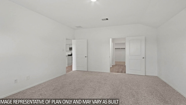 unfurnished bedroom featuring a spacious closet and light carpet