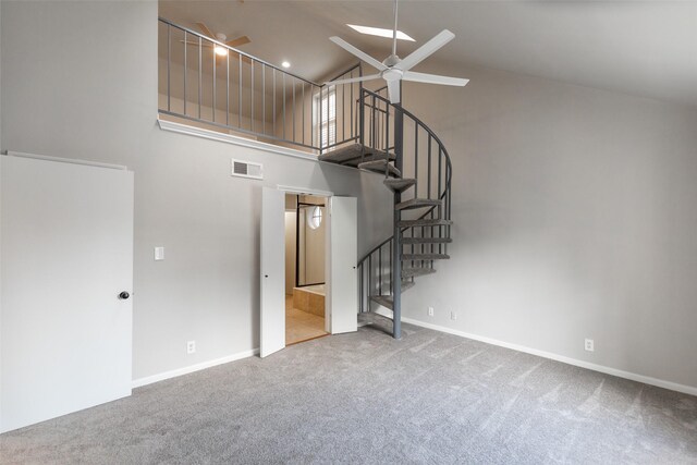 unfurnished living room featuring carpet floors, ceiling fan, and high vaulted ceiling