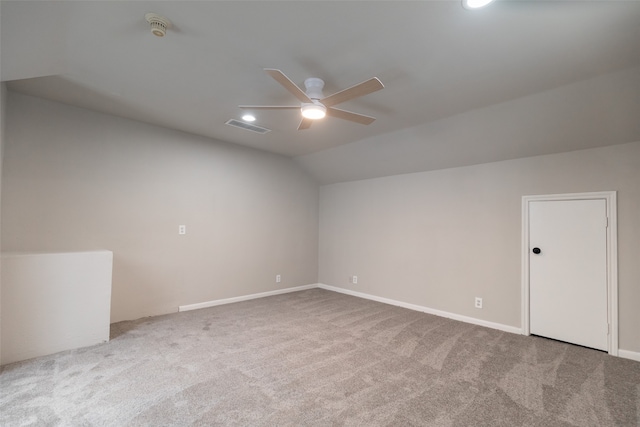 additional living space featuring vaulted ceiling, carpet, and ceiling fan