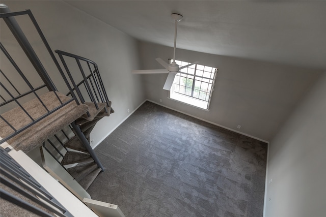 interior space featuring dark colored carpet, lofted ceiling, and ceiling fan