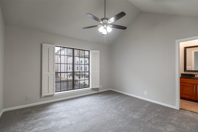 spare room featuring carpet, ceiling fan, and vaulted ceiling