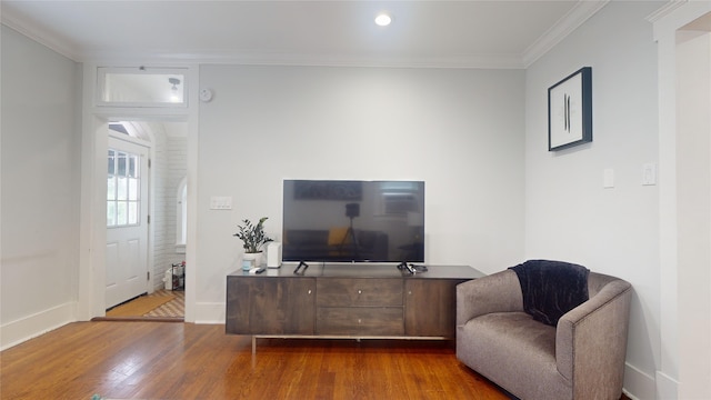 sitting room featuring crown molding and hardwood / wood-style floors