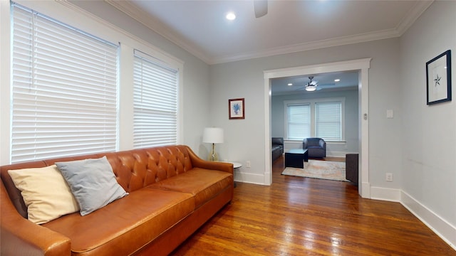 living room with crown molding, dark hardwood / wood-style flooring, and ceiling fan