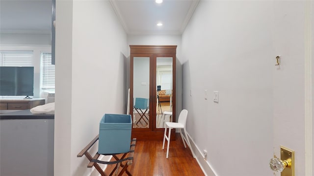 hallway featuring crown molding and hardwood / wood-style floors