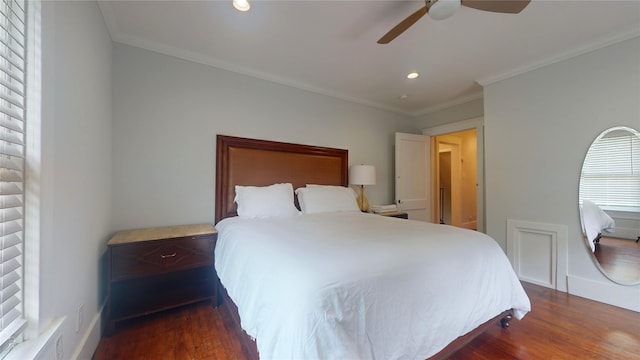 bedroom with dark hardwood / wood-style flooring, ceiling fan, and crown molding