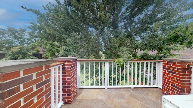 view of patio featuring a balcony