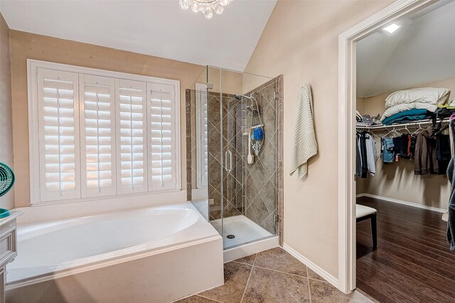 bathroom featuring lofted ceiling and independent shower and bath