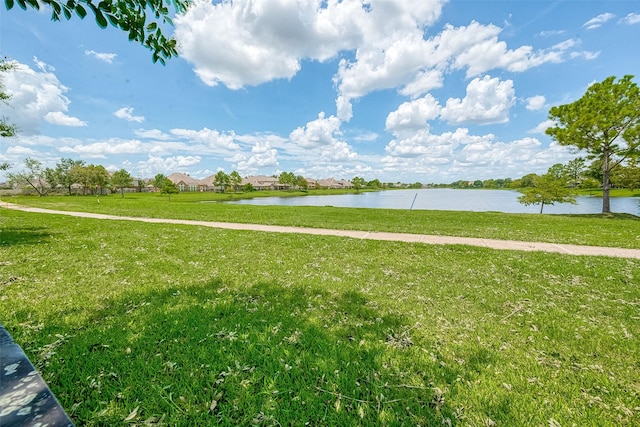 exterior space featuring a water view and a lawn