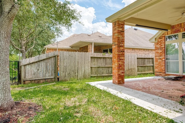 view of yard featuring a patio area and ceiling fan