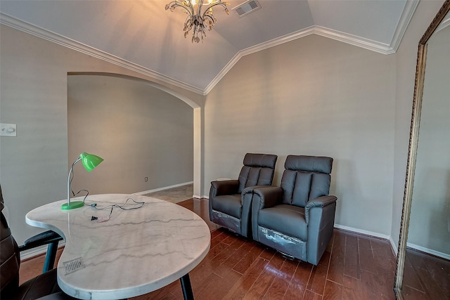 living area featuring dark wood-type flooring, ornamental molding, lofted ceiling, and a notable chandelier