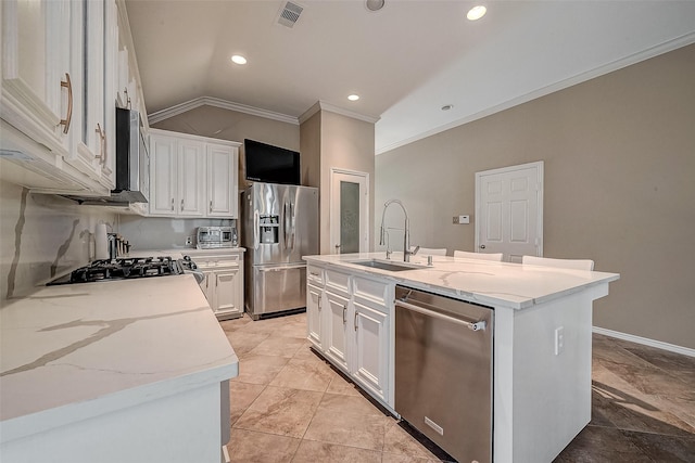 kitchen with white cabinetry, appliances with stainless steel finishes, sink, and a center island with sink