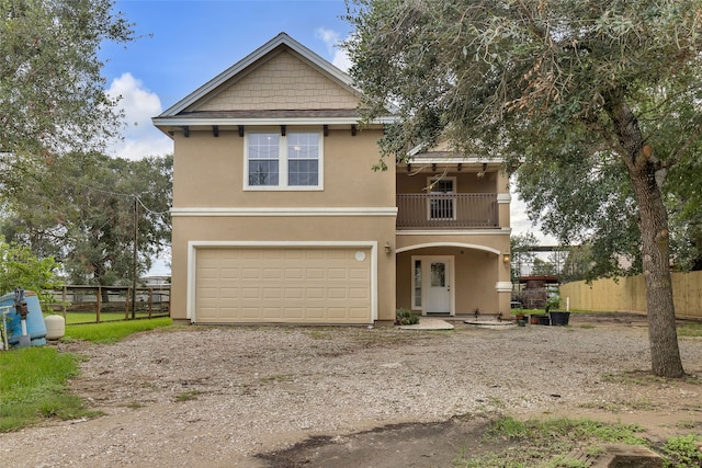 view of front of house with a balcony and a garage