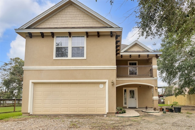 view of front of house featuring a balcony and a garage