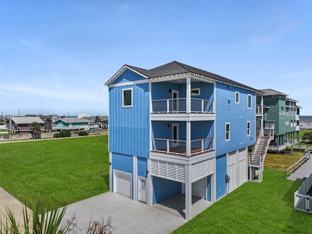 exterior space featuring a balcony, a garage, and a lawn