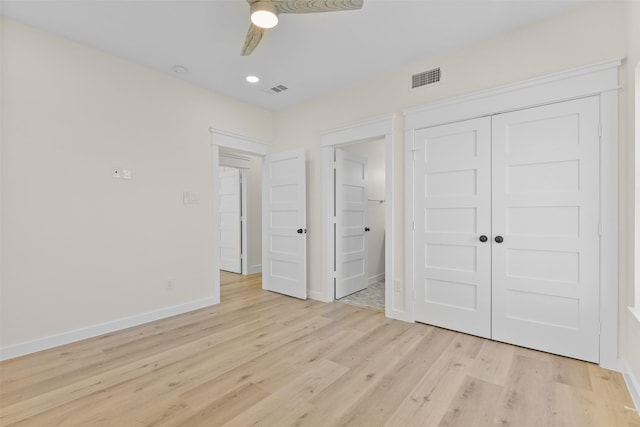 unfurnished bedroom with ceiling fan, light hardwood / wood-style flooring, and a closet