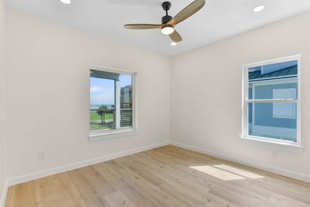 empty room featuring light wood-type flooring and ceiling fan