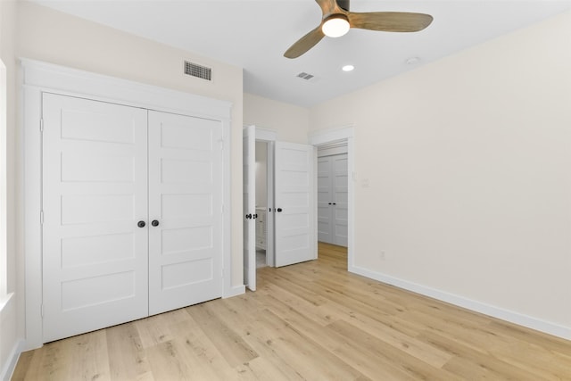 unfurnished bedroom with ceiling fan, a closet, and light hardwood / wood-style flooring