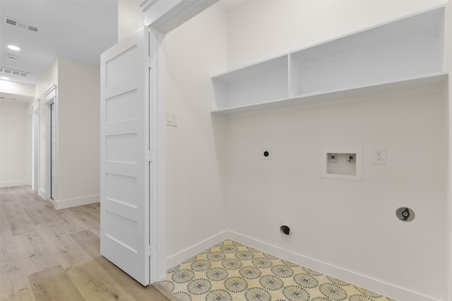 clothes washing area featuring washer hookup, light hardwood / wood-style flooring, and electric dryer hookup