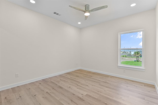 unfurnished room with light wood-type flooring and ceiling fan