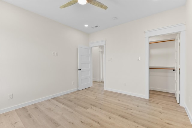 unfurnished bedroom featuring a closet, ceiling fan, and light wood-type flooring