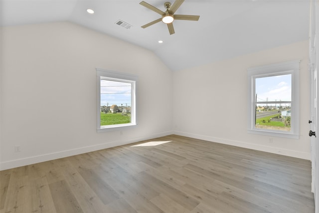 empty room featuring ceiling fan, light hardwood / wood-style flooring, and lofted ceiling