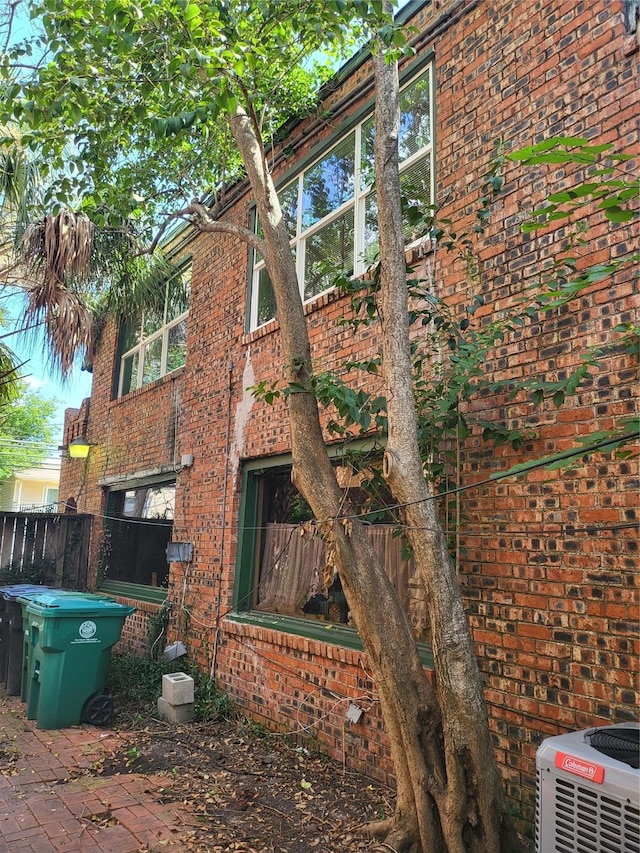 view of side of home with central AC unit