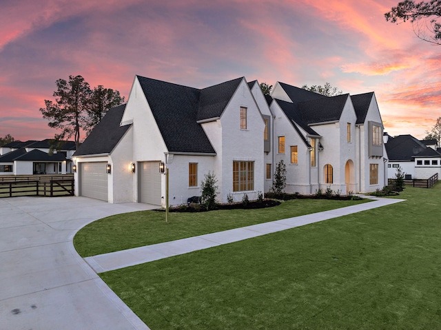 view of front of home featuring a garage, a shingled roof, fence, concrete driveway, and a front yard