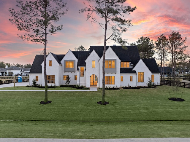 modern inspired farmhouse with a front yard and fence