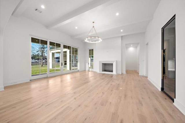 unfurnished living room with beam ceiling, a fireplace, visible vents, light wood-style floors, and baseboards