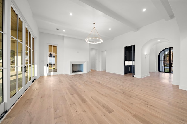 unfurnished living room with light wood-type flooring, a fireplace, beam ceiling, and recessed lighting