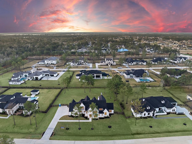 aerial view at dusk featuring a residential view