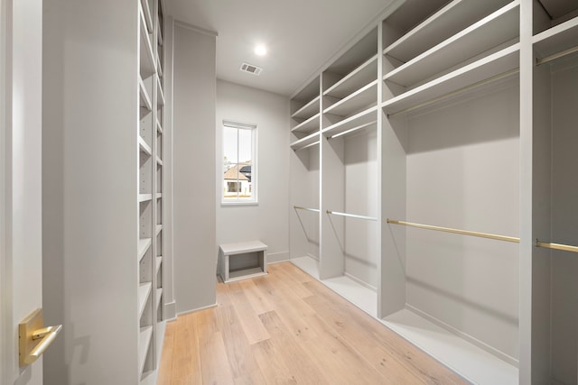 walk in closet featuring light wood-style flooring and visible vents