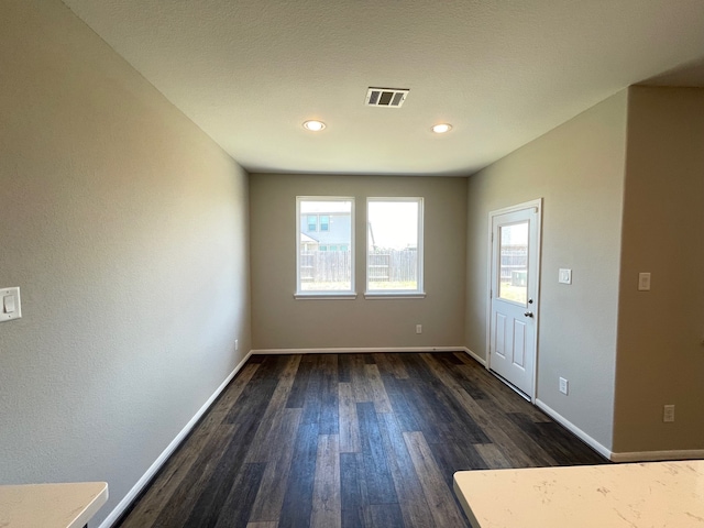 empty room with dark wood-type flooring