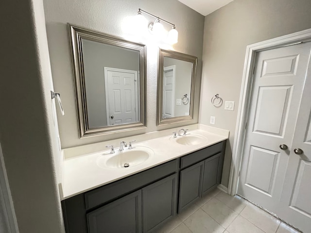 bathroom with tile patterned floors and double sink vanity