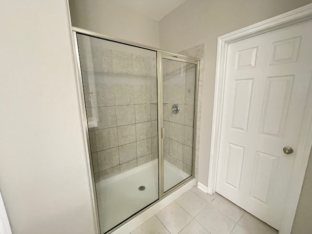 bathroom featuring tile patterned flooring and an enclosed shower