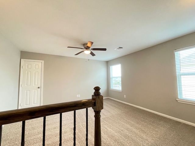 interior space featuring carpet floors and ceiling fan