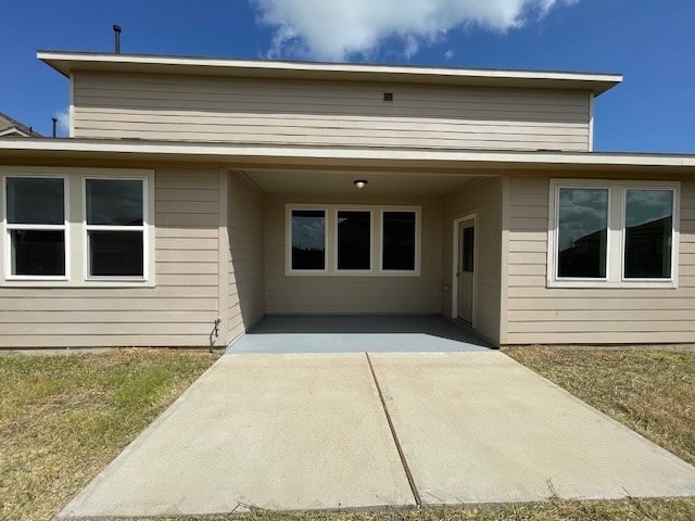 back of property with a patio