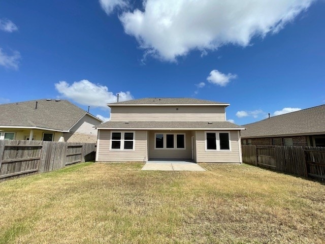 back of house featuring a patio and a yard