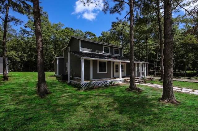 view of front of house with a front yard and covered porch