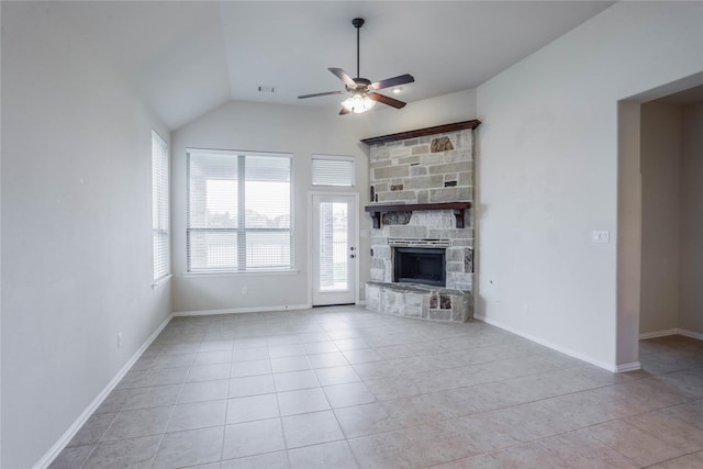 unfurnished living room featuring ceiling fan, a stone fireplace, lofted ceiling, and light tile patterned floors