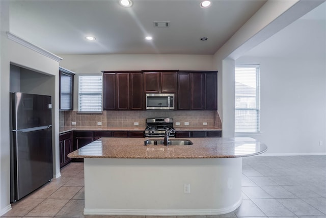 kitchen with tasteful backsplash, a healthy amount of sunlight, and stainless steel appliances