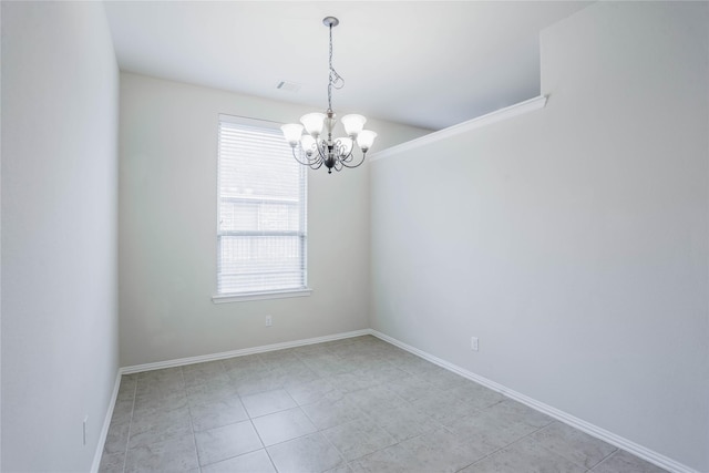 tiled empty room with an inviting chandelier