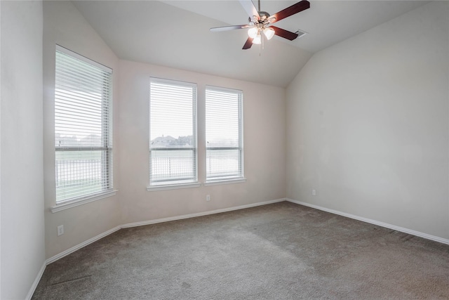 carpeted empty room featuring ceiling fan and lofted ceiling