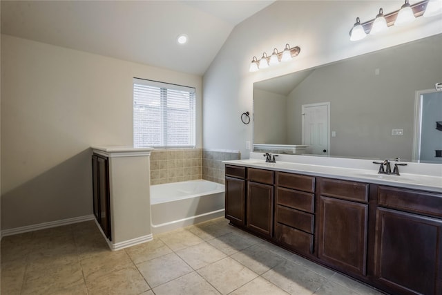 bathroom featuring vanity, tile patterned floors, a bathtub, and lofted ceiling