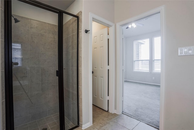 bathroom with ceiling fan, tile patterned flooring, and walk in shower