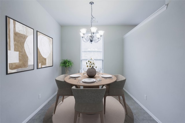 dining room featuring a chandelier and dark tile patterned floors