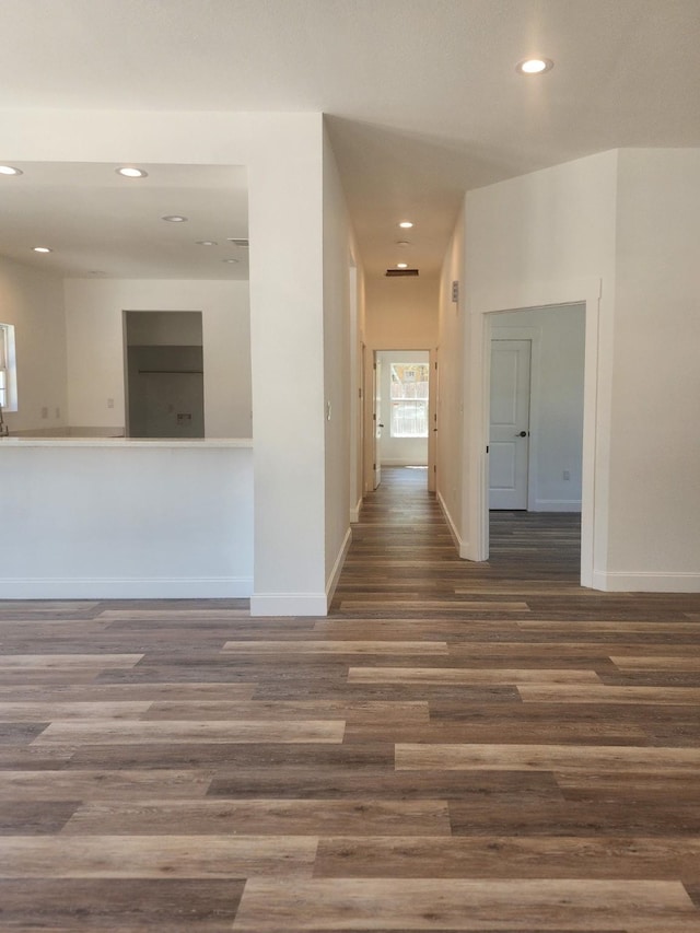 hallway with dark hardwood / wood-style flooring