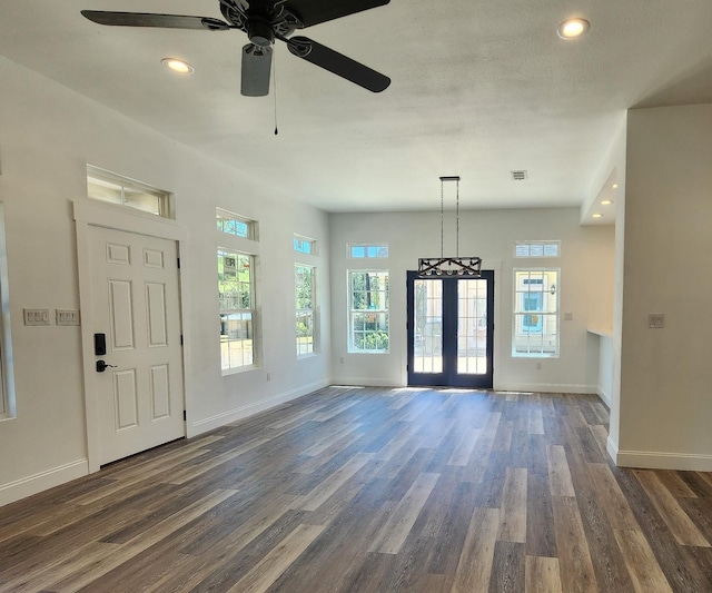 entryway featuring ceiling fan, french doors, and dark wood-type flooring