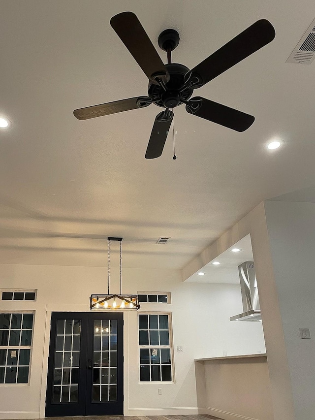 room details with ceiling fan with notable chandelier