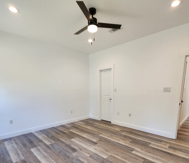 empty room featuring hardwood / wood-style flooring and ceiling fan